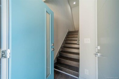 Main entrance on lower level opens to stairway and