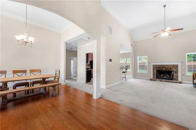 Carpeted dining area featuring crown molding, high