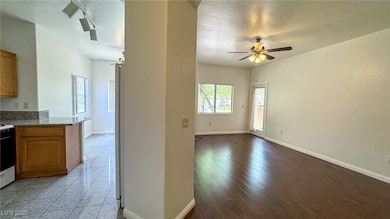 Kitchen featuring a ceiling fan, open floor plan,