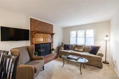 Living room features wood burning fireplace with b