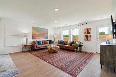 Living room featuring baseboards, wood finished fl
