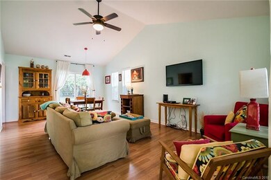 Open living area is spacious with hardwood floor a