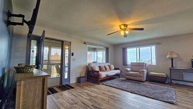 Welcoming living room with lots of windows for fresh air and mauka-makai breezes! Plenty space for kicking back, relaxing with friends, or taking in the peaceful Hawai‘i surroundings. Feels real comfortable, just like home in the islands.