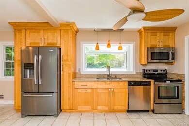 Large Eat-In Kitchen features custom cabinetry, gr