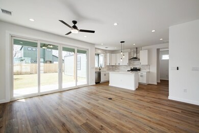Kitchen featuring light countertops, white cabine