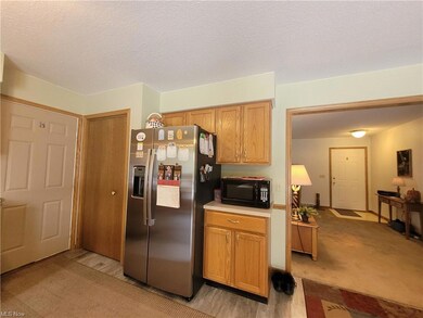 Kitchen featuring light carpet, stainless steel fr