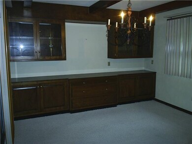 Dining Room. To the left is Sun Rm, this pic is taken from the FR. Family Rm & Dining Rm are one large open area, 2 diff sized rooms that run together but have different walls & different carpets. This window faces E, the cabinet side of the Rm is N 