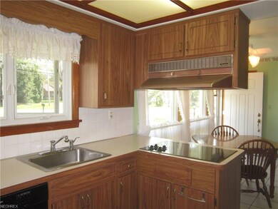 Kitchen has modern cooktop & plenty of storage.