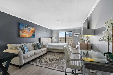 Bedroom featuring a textured ceiling, a textured w