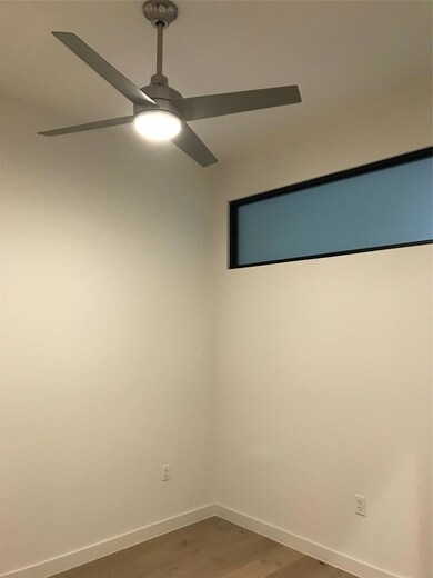 Spare room featuring wood finished floors and a c
