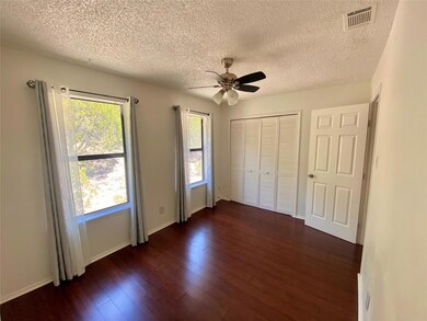 Unfurnished bedroom featuring dark wood-style flo