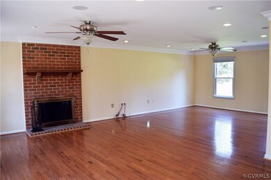 Huge 28 x 16 family room with beautiful hardwood floors, built in surround sound, recessed lighting, double member crown molding, twin ceiling fans and wood burning fireplace.