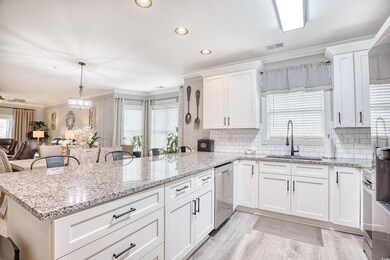 Kitchen with sink, tasteful backsplash, light hard