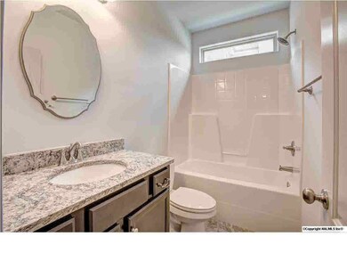 A full bath separates bedrooms 2 and 3.  Notice the granite counter top!