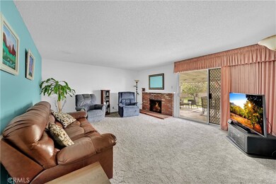 Your Living Room Has A Cozy Brick Accented Fireplace With Wood Mantle And Large Slider Doors To The Backyard
