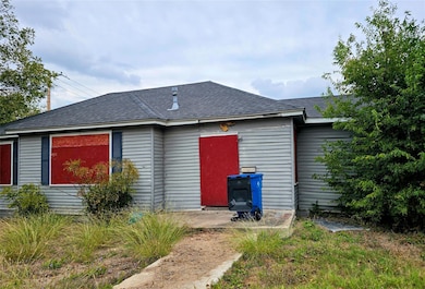 Back of property featuring roof with shingles and a patio area