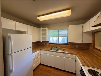 Kitchen with light countertops, a sink, white app