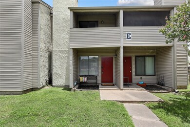 Property entrance featuring a yard, a balcony, and