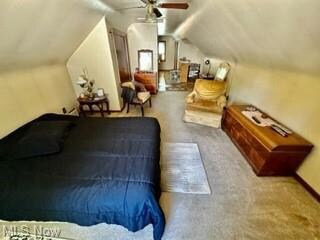 Bedroom with vaulted ceiling, light carpet, and ce