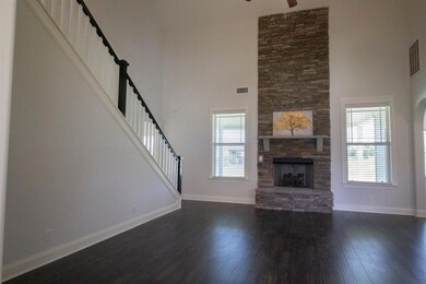 Make your nights comfy next to this stacked stone two story gas fireplace. Notice these gorgeous floors that run throughout the entire living areas, including the hall, laundry room and half bath. 