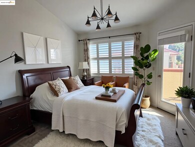 Carpeted bedroom featuring lofted ceiling and access to outside