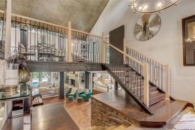 Staircase with a chandelier and a high ceiling