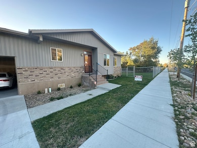 View of front of property with brick siding, board and batten siding, and a gate
