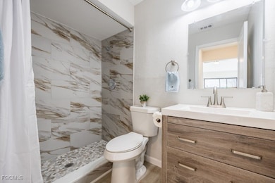 Bathroom with vanity and a tile shower
