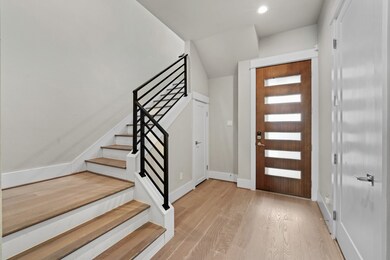 This entryway features a modern wooden door with f