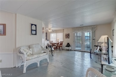 Living room with french doors and ceiling fan