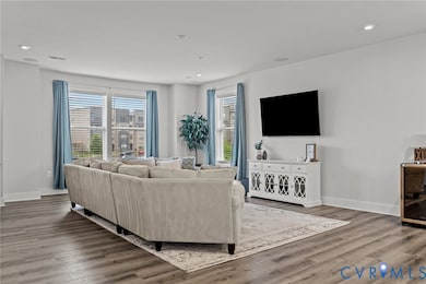 Living area with recessed lighting, wood finished floors, and beverage cooler