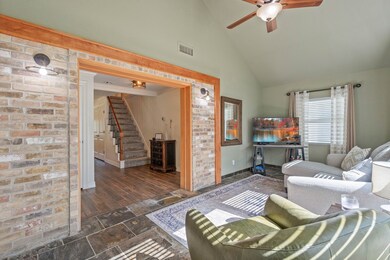 Expanded look at the living area showcasing the brick accent wall.