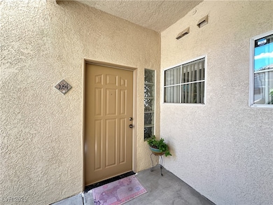 Entrance to property featuring stucco siding