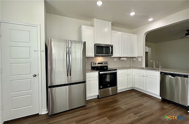 Kitchen with stainless steel appliances, pantry, garbage disposal, microwave, dishwasher, electric range, open to the living room and dining area