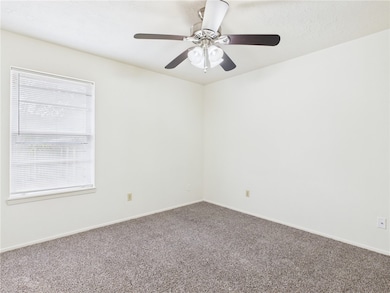 Carpeted empty room with baseboards