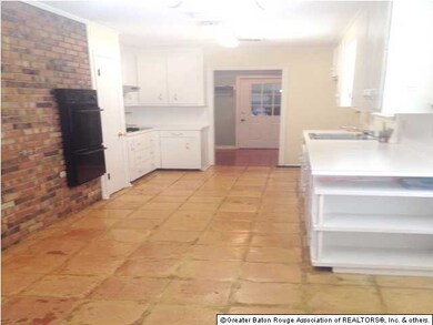 Kitchen has brick accent wall