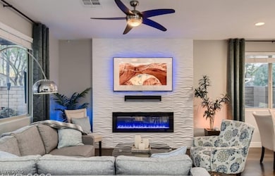 Living area with a ceiling fan, recessed lighting,