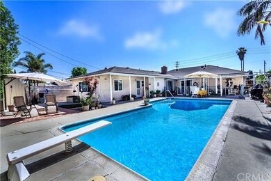 other end of the pool with patio and garden area t