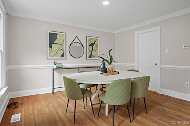 Dining space featuring wood finished floors, ornam
