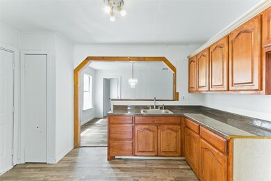 Kitchen with sink, a chandelier, decorative light 