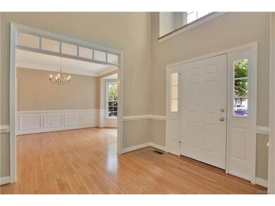 2-Story foyer with wood floor, chair rail, transom