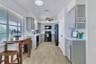 This kitchen features modern appliances, light gra