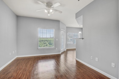 Unfurnished living room with ceiling fan and dark