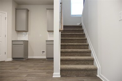 Stairway with wood finished floors and baseboards