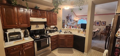 Kitchen featuring a toaster, electric range, under