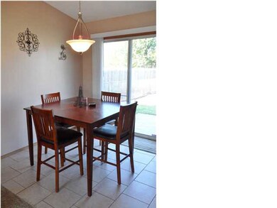 Dining room with tiled floors and exit onto the ba