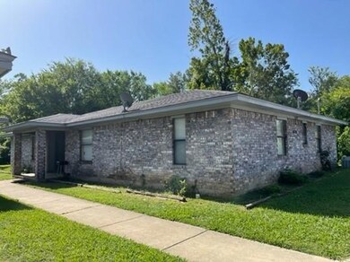 View of side of home with a lawn