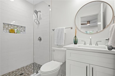 Full bathroom featuring a stall shower and vanity