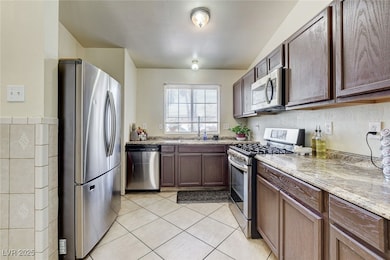 Kitchen featuring stainless steel appliances, ligh