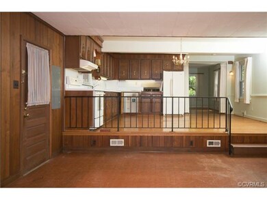 The kitchen opens directly into the family room, which has wood paneling, built-in shelves and leads to the Florida room.